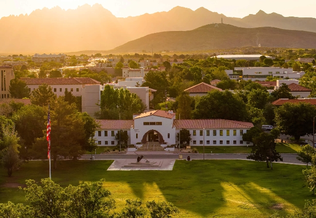 An aerial view of the sun setting over NMSU's campus