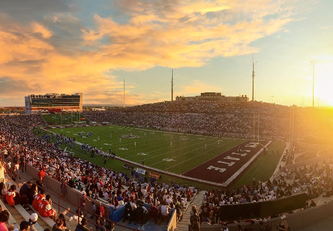 An aerial shot of the sun setting on Aggie Memorial Stadium