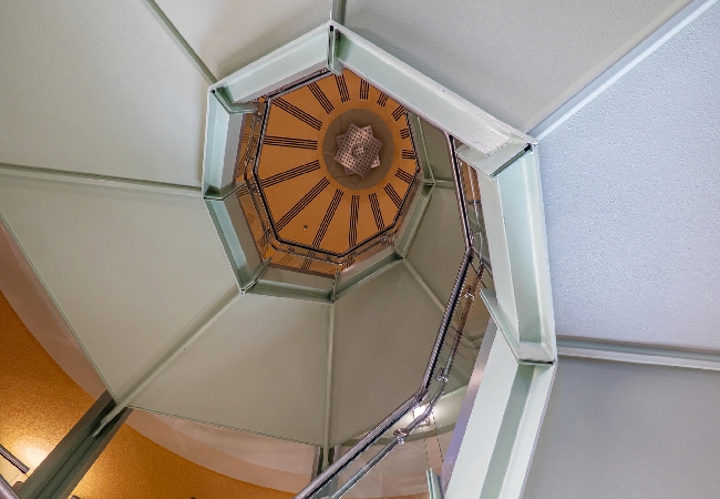 A view of a spiral staircase from the bottom looking up.