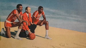(Left to right) Jimmy Collins, New Mexico State head coach Lou Henson and Sam Lacey pose for a photo during the 1969-1970 season. Photo credit: Nathan J Fish/Sun-News